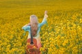 sexy woman in the field with a guitar. concept freedom, inspiration, relaxation. Royalty Free Stock Photo
