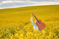 sexy woman in the field with a guitar. concept freedom, inspiration, relaxation.