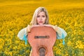 sexy woman in the field with a guitar. concept freedom, inspiration, relaxation. Royalty Free Stock Photo