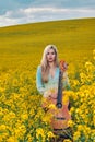 sexy woman in the field with a guitar. concept freedom, inspiration, relaxation. Royalty Free Stock Photo