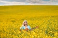 sexy woman in the field with a guitar. concept freedom, inspiration, relaxation. Royalty Free Stock Photo