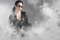 woman holding gun with helmet over smoke Royalty Free Stock Photo