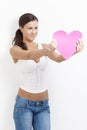 woman holding paper heart smiling