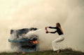 woman with long hair at piano on fire, Halloween. Music style and art. Fire and smoke on grunge instrument Royalty Free Stock Photo