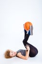 woman lying on the floor with basketball ball Royalty Free Stock Photo