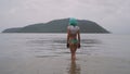 woman in modern futuristic style with blue wig posing in the sea