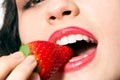 woman mouth biting strawberry Royalty Free Stock Photo