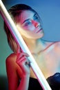 woman in neon light in lingerie. Neon lights and glare of light on the girls face. Naked woman in sequins on the background Royalty Free Stock Photo