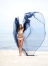 woman posing with silk on the beach Royalty Free Stock Photo
