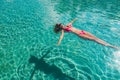 woman in red bikini floating on deep swimming pool Royalty Free Stock Photo