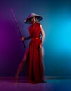 sexy woman in a red cape and an Asian hat with a katana in her hand image of a samurai in neon color