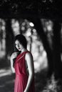woman in red dress in fairy forest. Beauty springtime Royalty Free Stock Photo