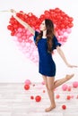 brunette woman with red heart balloons and flowers