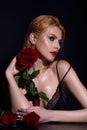 Sexy woman with red rose. Fashion portrait of young beautiful lady with flowers. Portrait of elegant beautiful woman Royalty Free Stock Photo