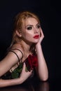 Sexy woman with red rose. Fashion portrait of young beautiful lady with flowers. Portrait of elegant beautiful woman Royalty Free Stock Photo