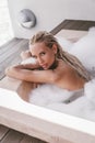 woman relaxing in luxurious outdoor jacuzzi with foam Royalty Free Stock Photo