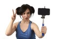 woman taking selfie photo with stick and mobile phone camera posing happy Royalty Free Stock Photo