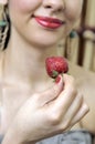 woman tasting a strawberry Royalty Free Stock Photo