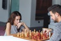 woman thinking the right move on chess table