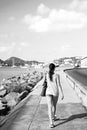 woman walk along sea in st.thomas, british virgin island. Woman in top and shorts on sea side promenade on sunny Royalty Free Stock Photo