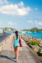 woman walk along sea in st.thomas, british virgin island. Woman in top and shorts on sea side promenade on sunny Royalty Free Stock Photo