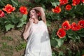 woman in white dress lying in red tulip field Royalty Free Stock Photo