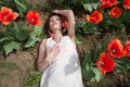 woman in white dress lying in red tulip field Royalty Free Stock Photo