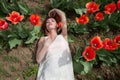 woman in white dress lying in red tulip field Royalty Free Stock Photo