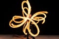 sexy woman artist perform fiery twirly trails by spinning flaming pois during fire performance