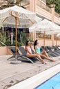 women in elegant swimming suit relaxing near swimming pool Royalty Free Stock Photo