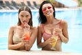 women in elegant swimming suit relaxing near swimming pool Royalty Free Stock Photo