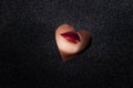 Sexy women`s lips with red lipstick in a heart-shaped cutout. Royalty Free Stock Photo