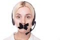 young blond woman in a headset looks up and can not speak, Royalty Free Stock Photo