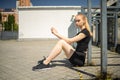 Sexy young blonde woman, exercising in city outdoor, lifestyle portrait. Royalty Free Stock Photo
