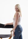 Beautiful young blonde woman in white tank top and blue jeans Royalty Free Stock Photo