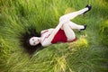 young brunette with red dress on green grass Royalty Free Stock Photo