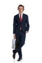 Sexy young businessman holding bag and posing with hand in pocket Royalty Free Stock Photo