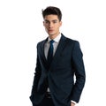 sexy young businessman in navy blue suit holding hands in pockets Royalty Free Stock Photo
