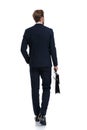 Sexy young businessman in navy blue suit holding suitcase Royalty Free Stock Photo