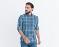 sexy young casual guy looking to side and walking on grey background Royalty Free Stock Photo