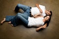 young ethnic couple relaxing on the floor Royalty Free Stock Photo