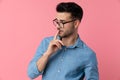 Sexy young guy looking to side and holding finger to mouth Royalty Free Stock Photo