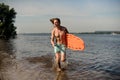 beach lifeguard running along the river bank with life-savi Royalty Free Stock Photo