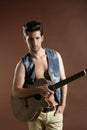 young man musician guitar player on brown Royalty Free Stock Photo