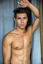 young man standing shirtless by curtains Royalty Free Stock Photo