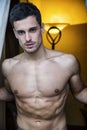 young man standing shirtless by curtains Royalty Free Stock Photo