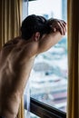 Sexy young man standing shirtless by curtains Royalty Free Stock Photo