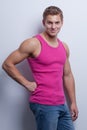 young man wearing undershirt and jeans, posing at white wal Royalty Free Stock Photo