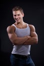 young man wearing white undershirt and jeans, posing over d Royalty Free Stock Photo