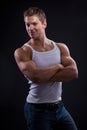 young man wearing white undershirt and jeans, posing over d Royalty Free Stock Photo